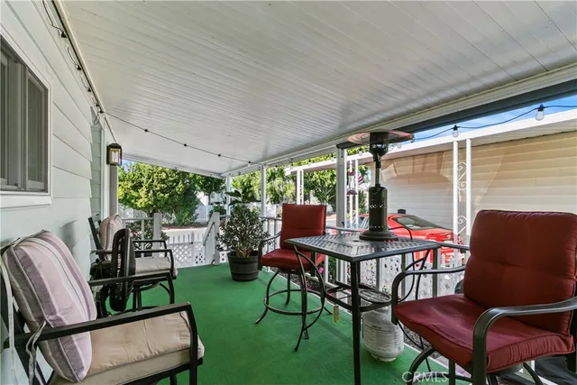 a view of a patio with table and chairs potted plants with wooden floor