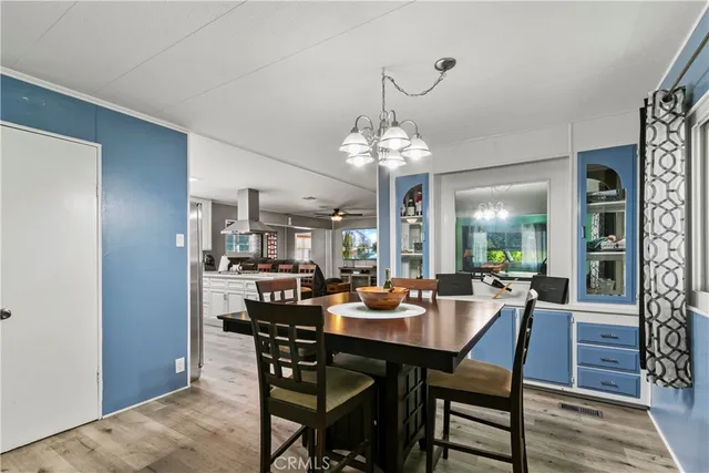 a view of a dining room with furniture and chandelier