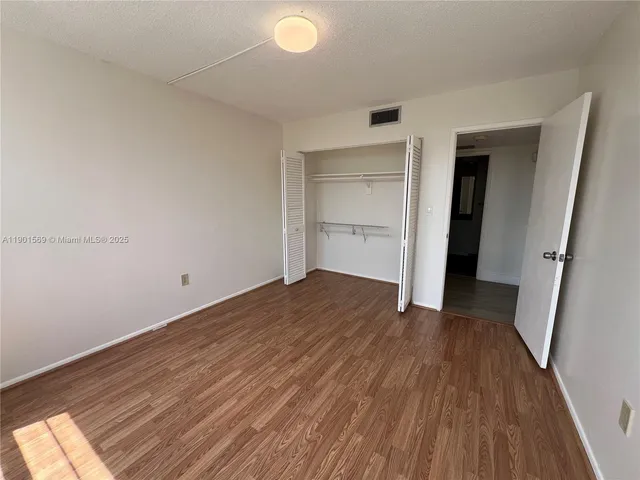 a view of a room with wooden floor and staircase