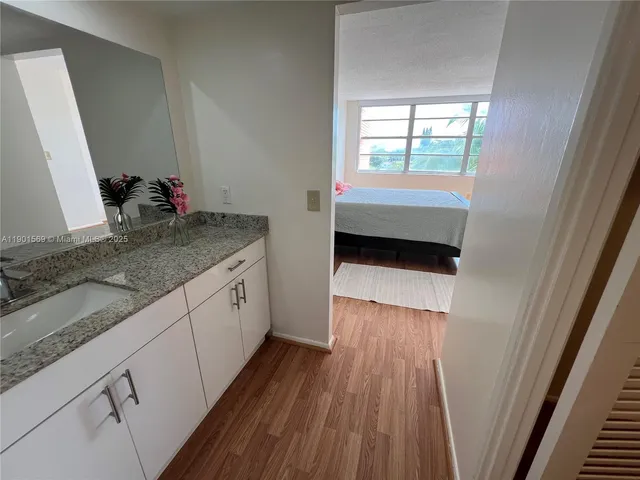 a view of a kitchen from a hallway