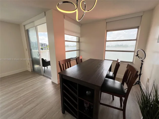 a view of a dining room with furniture and window