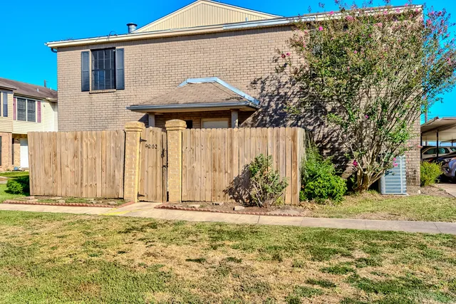 a backyard of a house with table and chairs