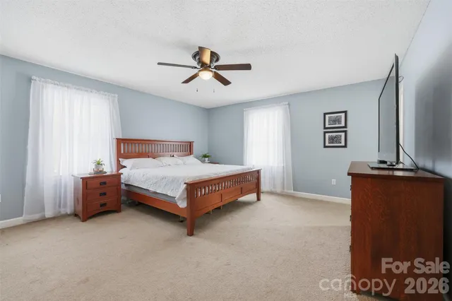 a blue bed sitting in a room with a chandelier