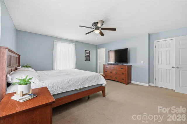 a bedroom with bed and window