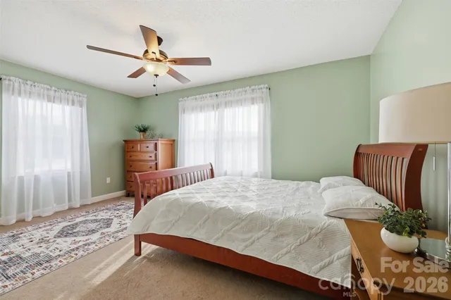a bedroom with a bed and ceiling fan