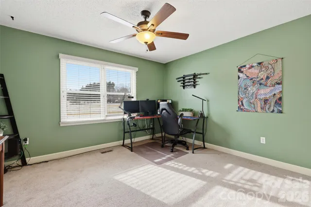 a view of a workspace with furniture and a window
