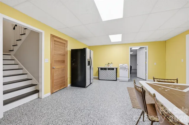 a view of a kitchen with furniture and an empty room