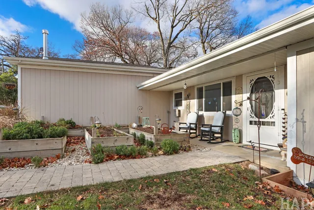 a front view of a house with outdoor seating