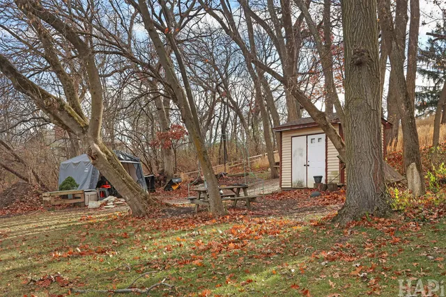 a backyard of a house with table and chairs