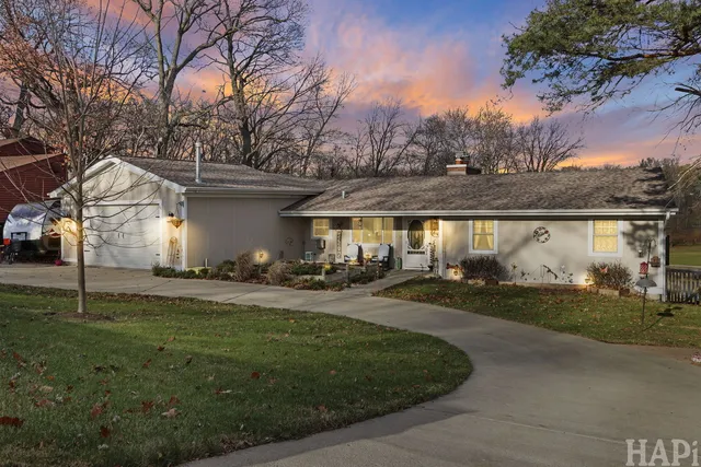 a view of a house with backyard and trees