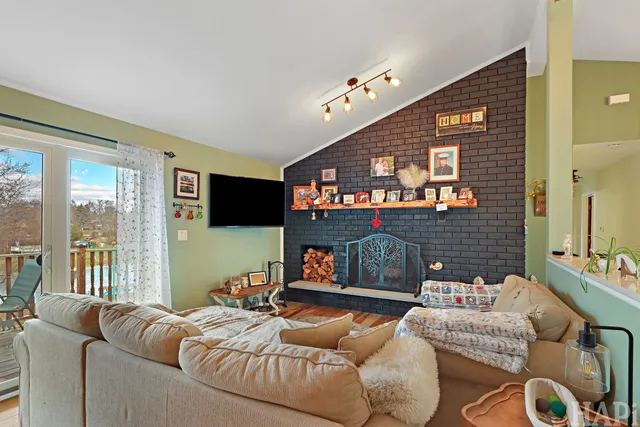 a living room with furniture a flat screen tv and a fireplace