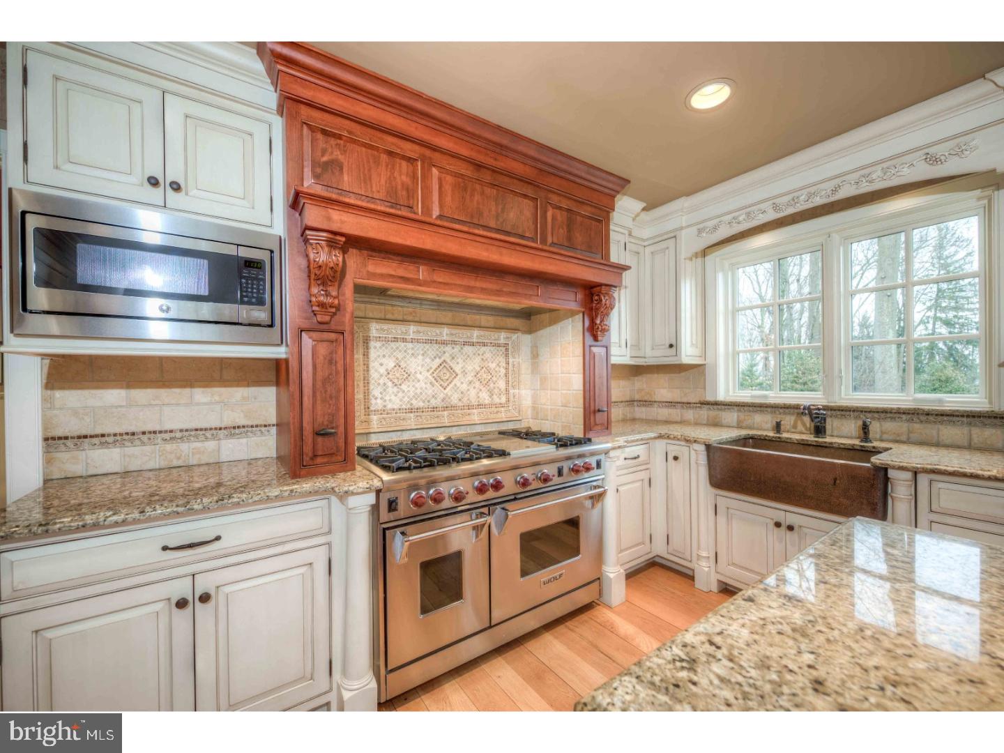 2 Dewitt Lane Wayne, PA 19087 - Photo 4 of 25 a kitchen with stainless steel appliances granite countertop a stove a sink and a microwave