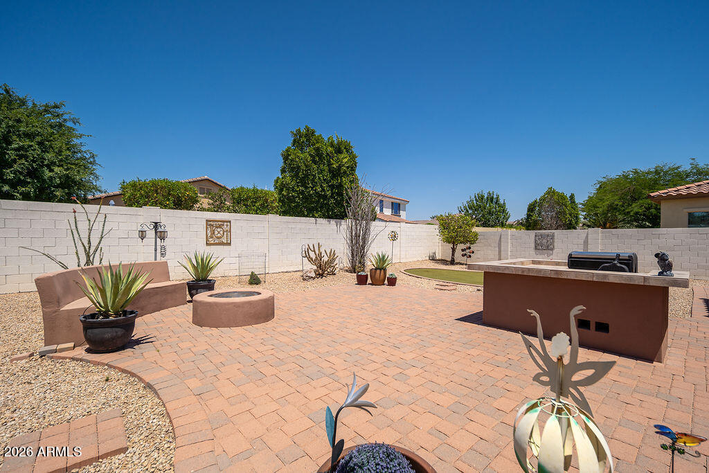 15730 West Harvard Street Goodyear, AZ 85395 - Photo 32 of 40 Extended Pavers and Bench at Firepit
