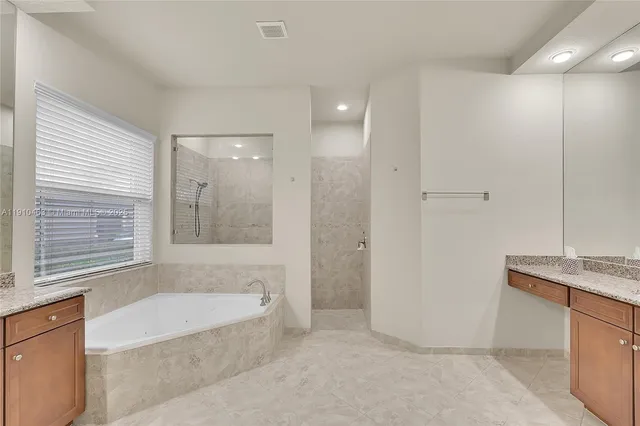 a bathroom with a bathtub and a sink