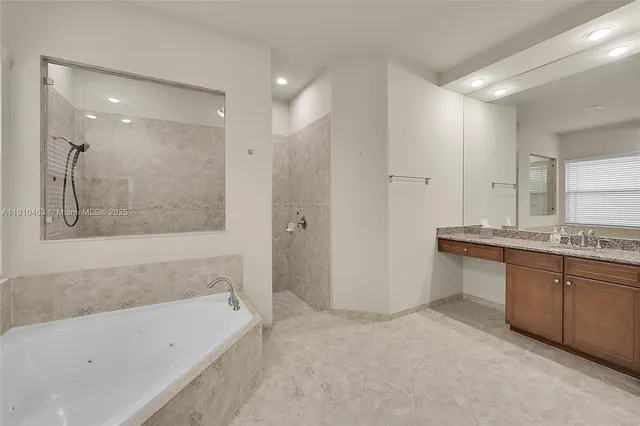 a bathroom with a bathtub and a sink
