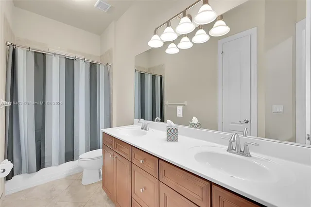 a view of a storage and utility room with sink dryer and cabinet