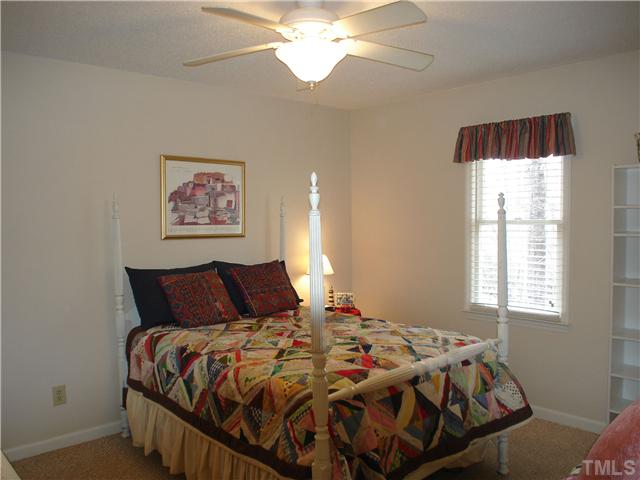 6921 Russell Road Durham, NC 27712 - Photo 10 of 12 a bedroom with a bed and a window