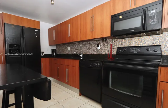 a kitchen with a sink stove and microwave