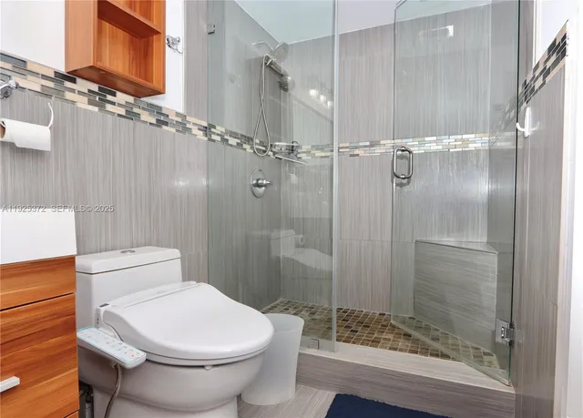 a bathroom with a toilet and shower