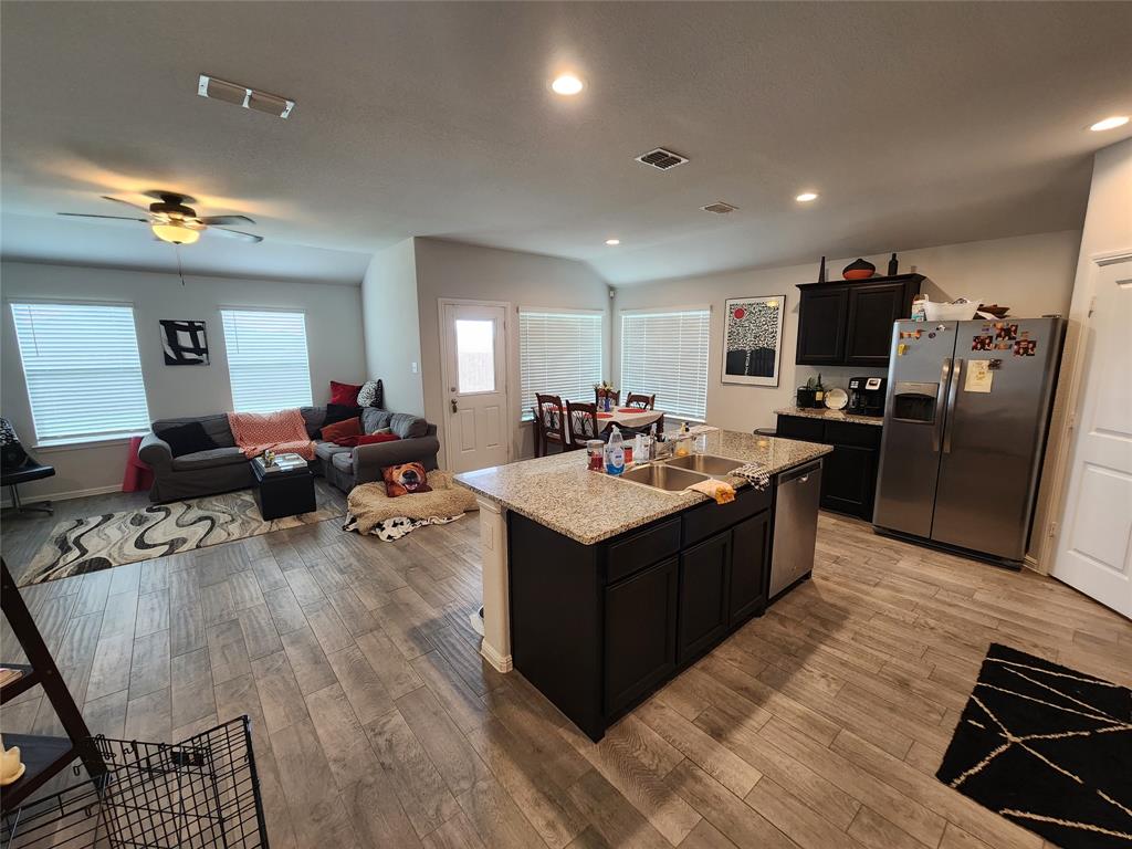 9240 Castorian Drive Fort Worth, TX 76131 - Photo 1 of 40 a large kitchen with stainless steel appliances a stove a sink dishwasher and a refrigerator with wooden floor
