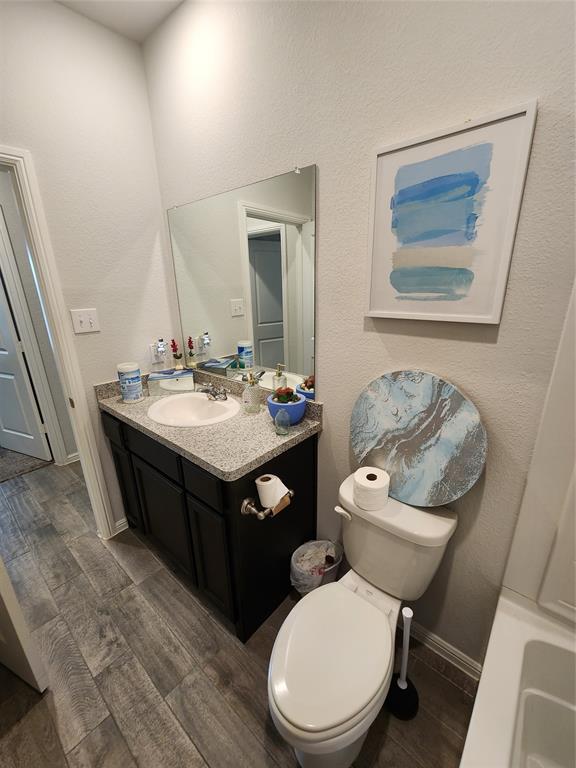 9240 Castorian Drive Fort Worth, TX 76131 - Photo 11 of 40 a bathroom with a toilet sink and mirror