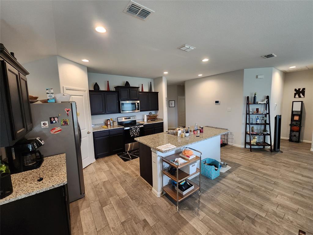 9240 Castorian Drive Fort Worth, TX 76131 - Photo 17 of 40 a room with furniture and a flat screen tv