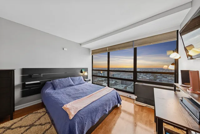 a bedroom with a bed and large window