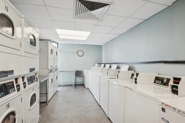 a utility room with multiple dryer and washer