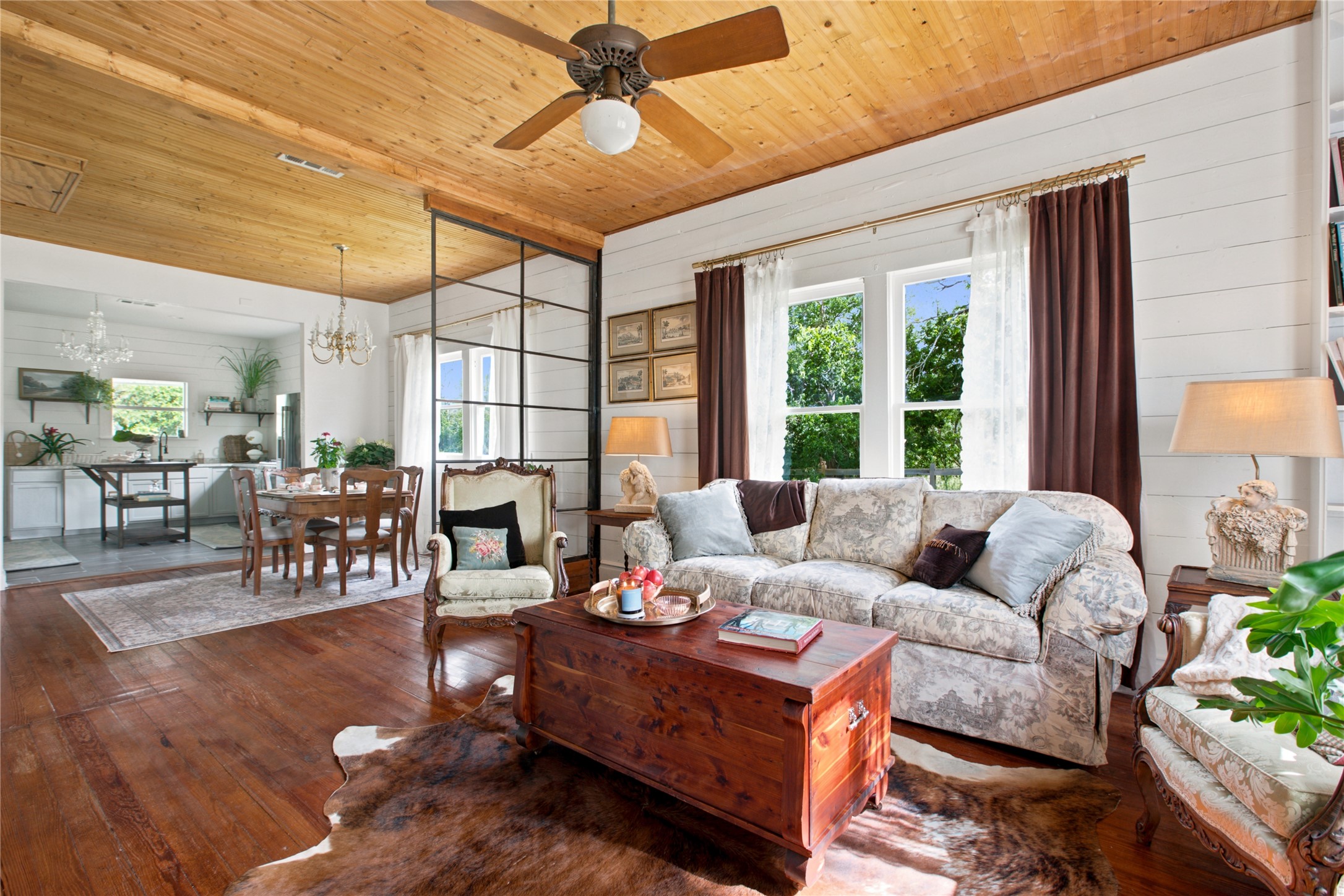 372 Old Lockhart Road Lockhart, TX 78644 - Photo 9 of 40 Rich hardwood flooring complements the natural wood ceiling, creating a warm and inviting atmosphere.