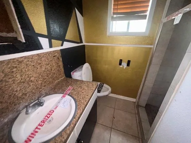 an empty room with closet and windows