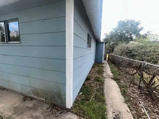 a view of a pathway of a house with a small yard