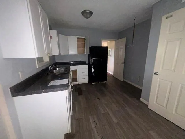 a kitchen with a refrigerator and a stove top oven