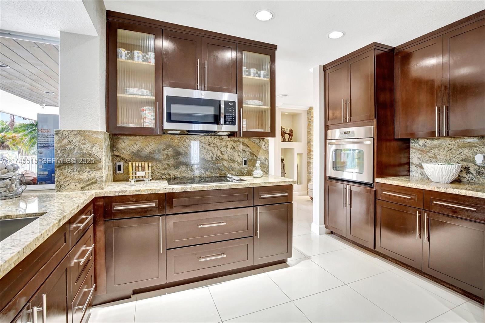 17500 Southwest 68th Court Southwest Ranches, FL 33331 - Photo 16 of 48 a kitchen with stainless steel appliances granite countertop a refrigerator and a sink