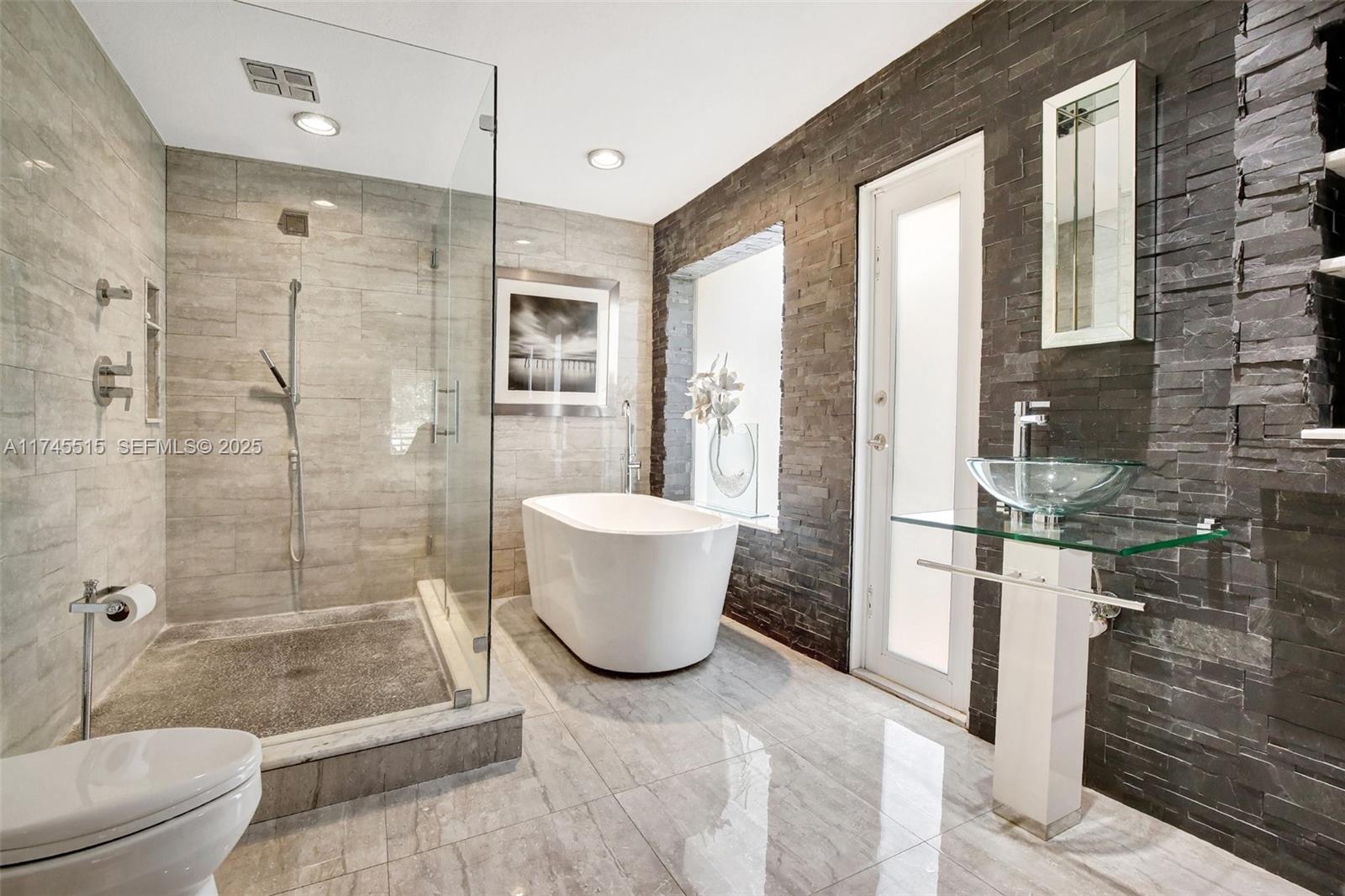 17500 Southwest 68th Court Southwest Ranches, FL 33331 - Photo 22 of 48 a bathroom with a bathtub and shower