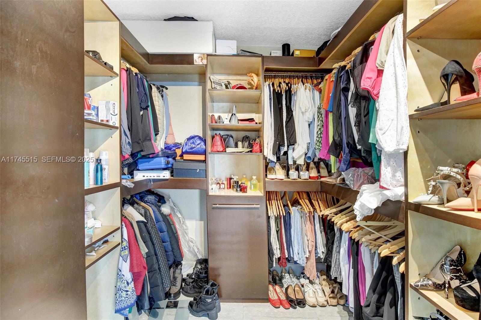 17500 Southwest 68th Court Southwest Ranches, FL 33331 - Photo 23 of 48 a view of walk in closet with clothes