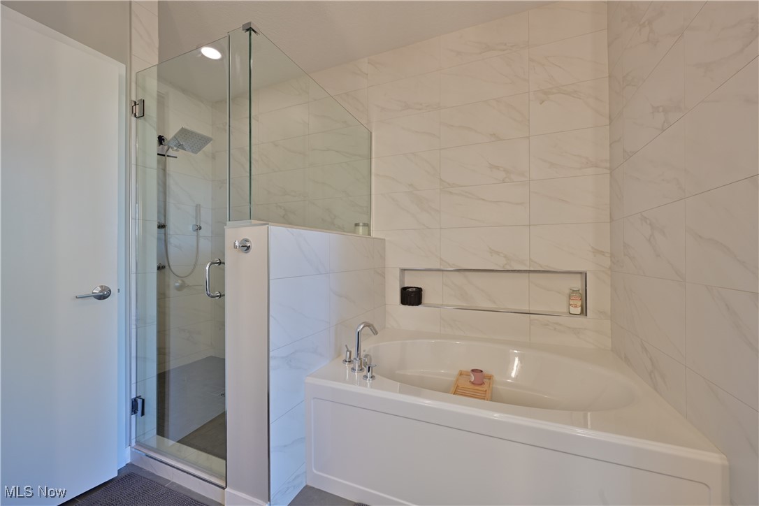 18875 Riversouth Fairview Park, Unit 30 Cleveland, OH 44126 - Photo 21 of 39 Bathroom with a bath, a shower stall, tile walls, and recessed lighting
