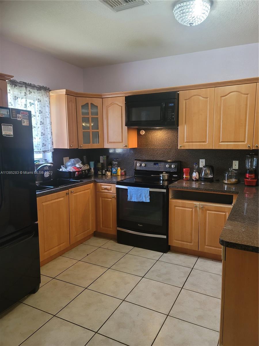 Florida City Florida City, FL 33034 - Photo 4 of 7 a kitchen with stainless steel appliances granite countertop a stove a sink dishwasher and a refrigerator