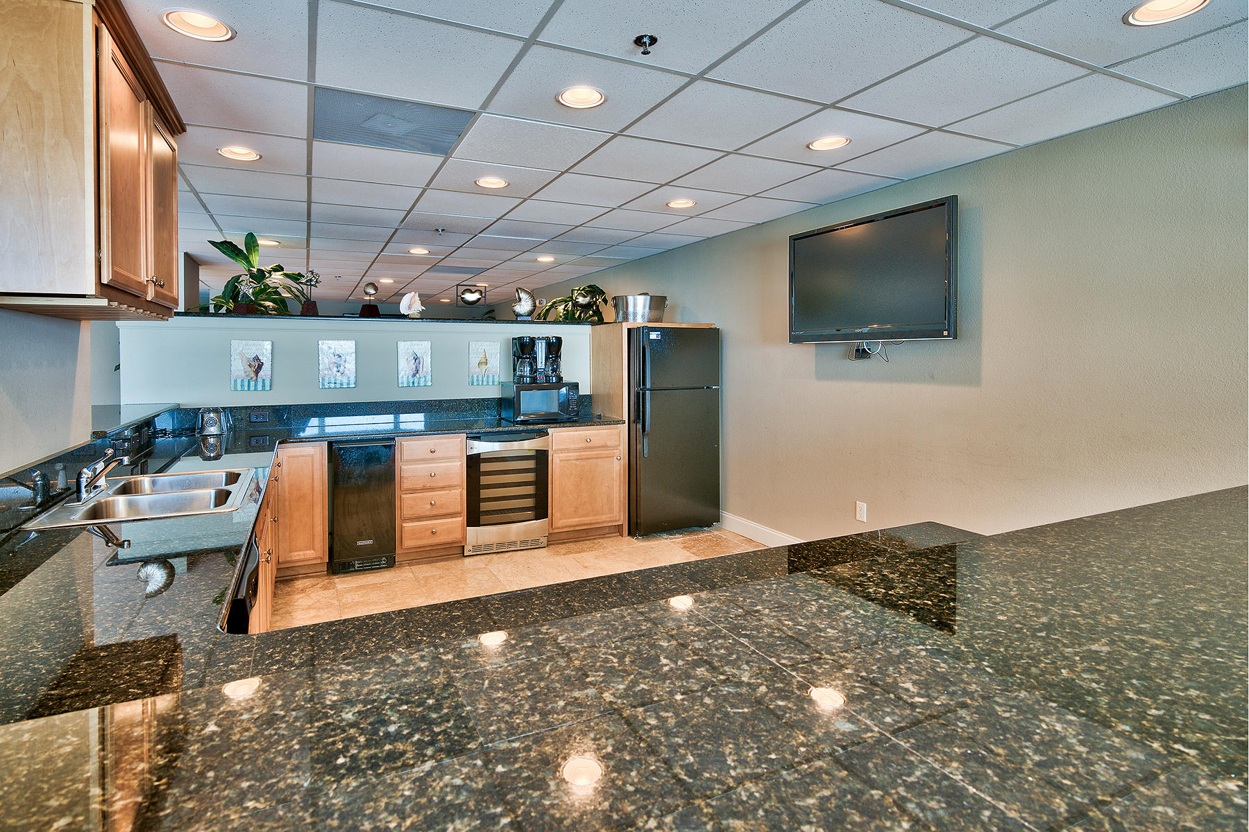 16819 Front Beach Road, Unit 1110 Panama City Beach, FL 32413 - Photo 27 of 34 a living room with stainless steel appliances kitchen island granite countertop a stove and a sink
