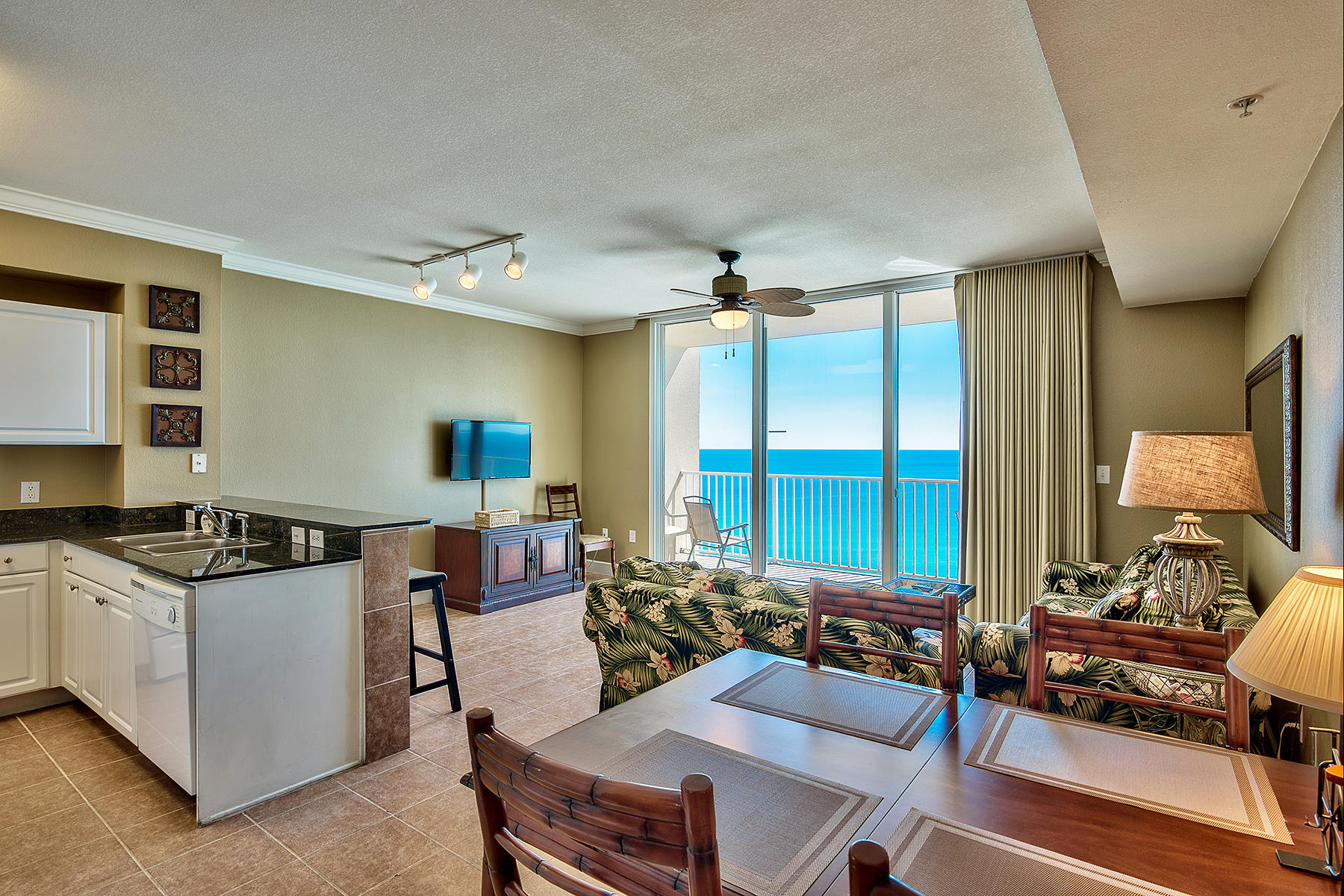 16819 Front Beach Road, Unit 1110 Panama City Beach, FL 32413 - Photo 5 of 34 a living room with furniture and a flat screen tv