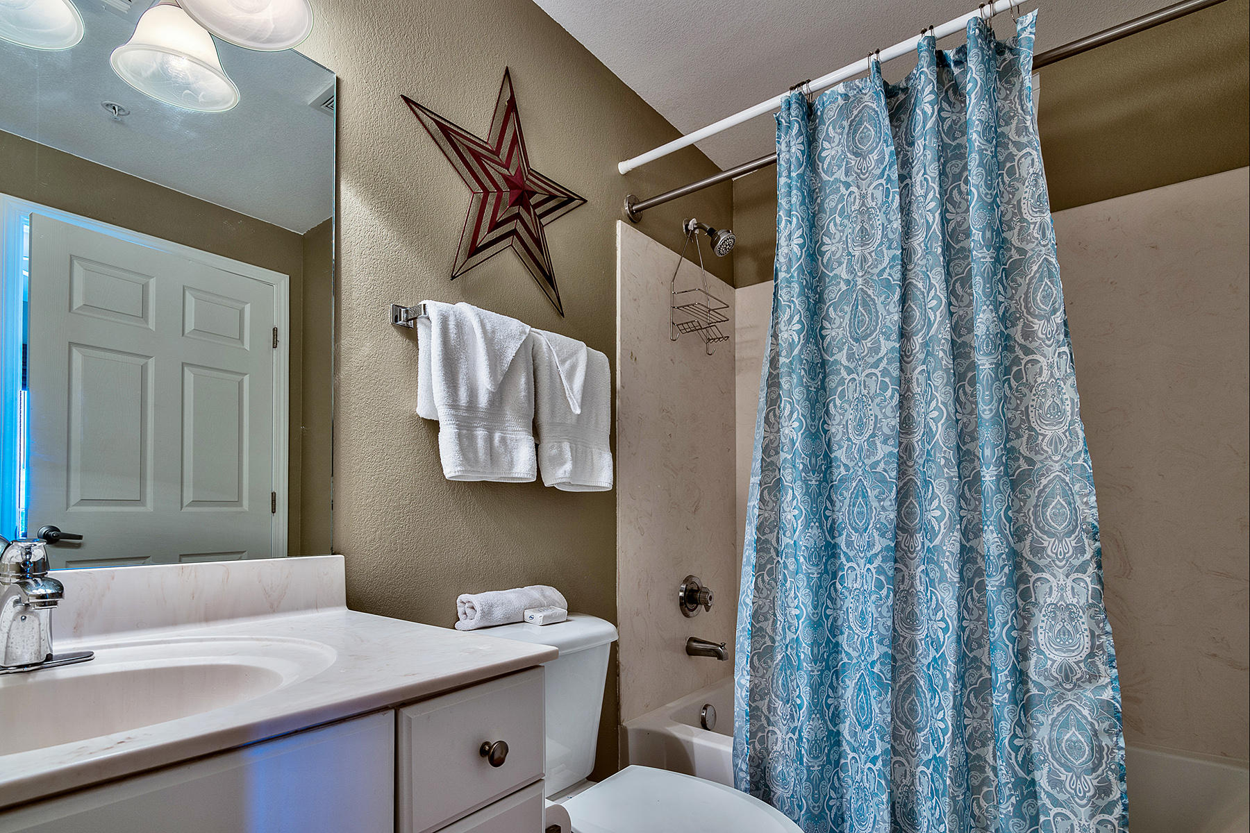 16819 Front Beach Road, Unit 1110 Panama City Beach, FL 32413 - Photo 8 of 34 a bathroom with a sink vanity mirror and toilet