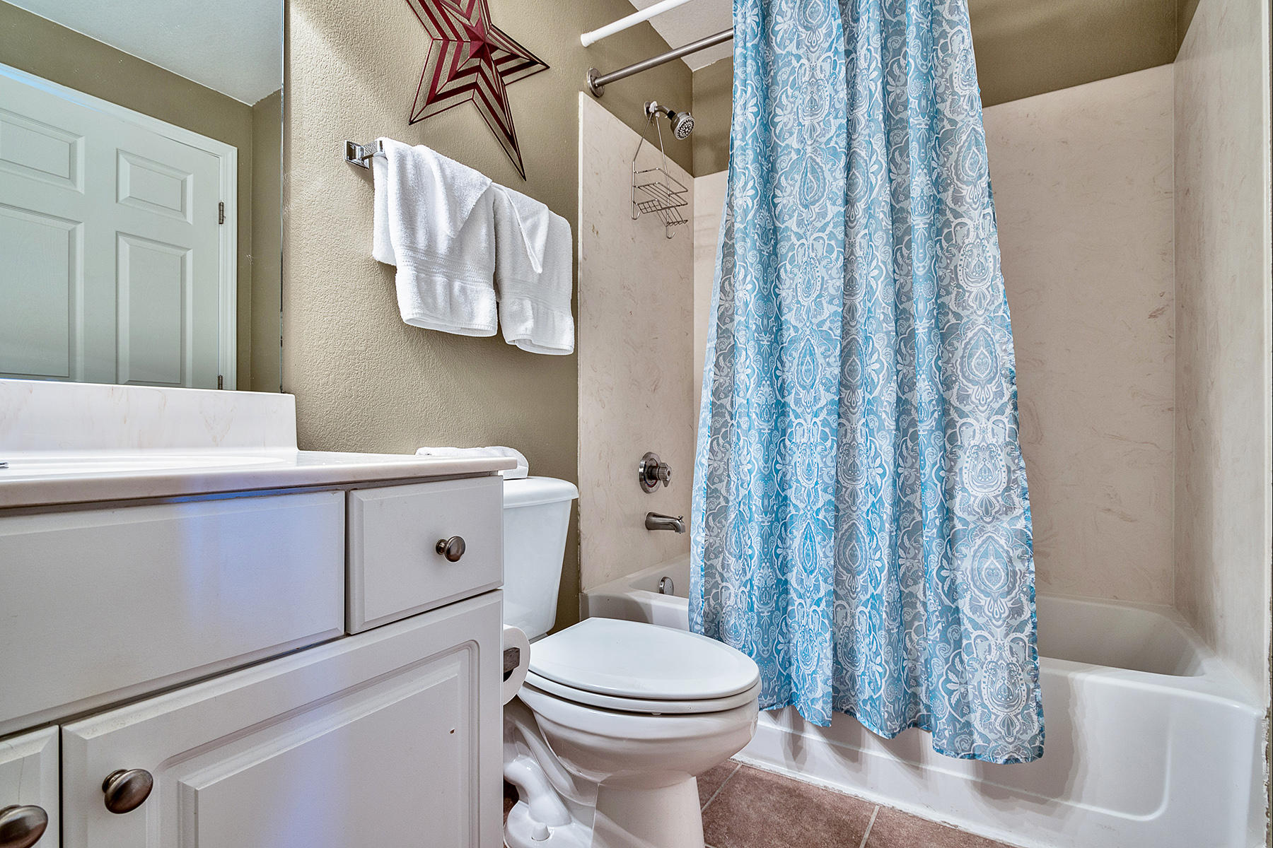 16819 Front Beach Road, Unit 1110 Panama City Beach, FL 32413 - Photo 10 of 34 a bathroom with a toilet sink and vanity