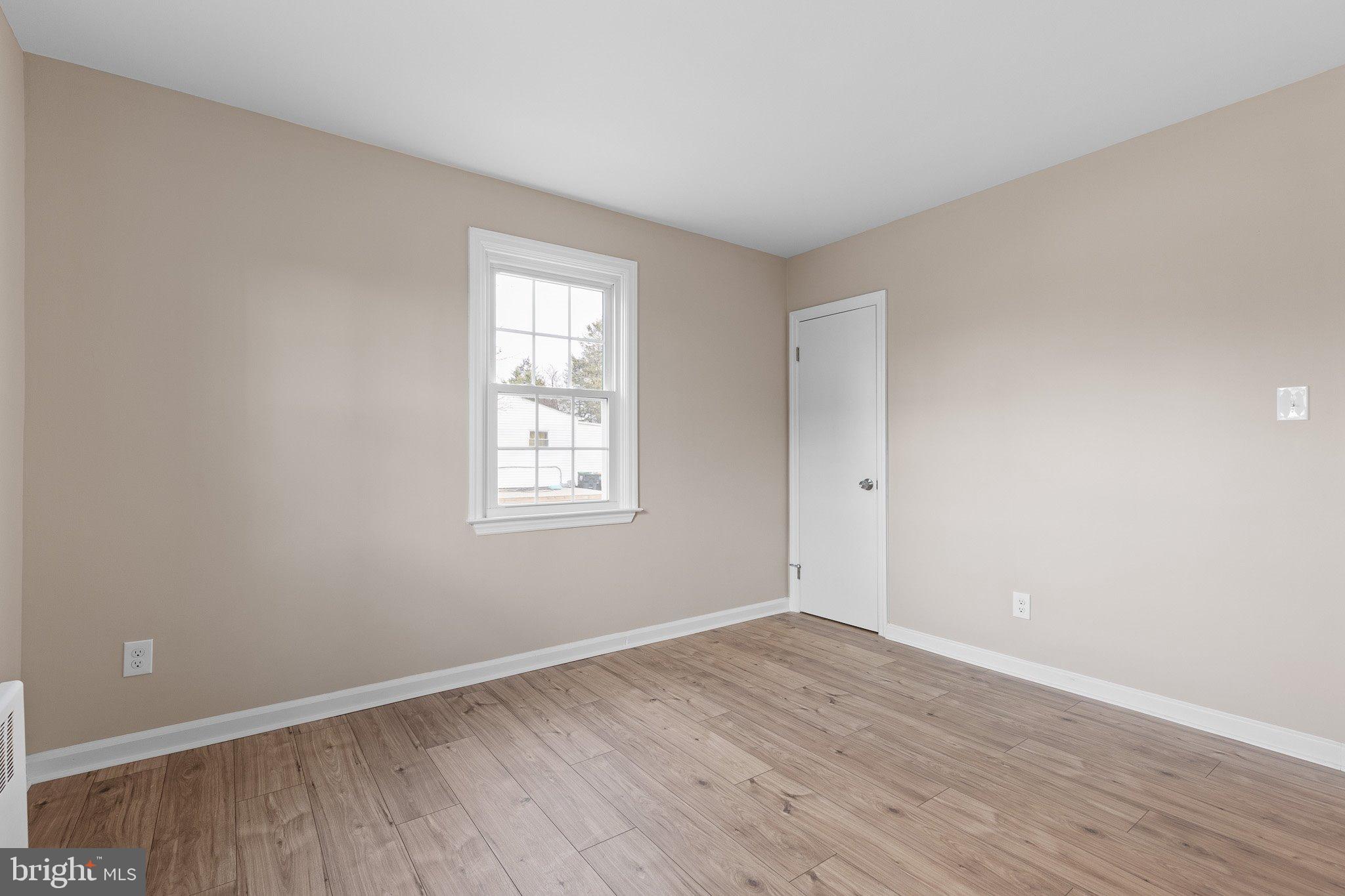 15 Irwin Avenue New Castle, DE 19720 - Photo 14 of 29 an empty room with wooden floor and windows