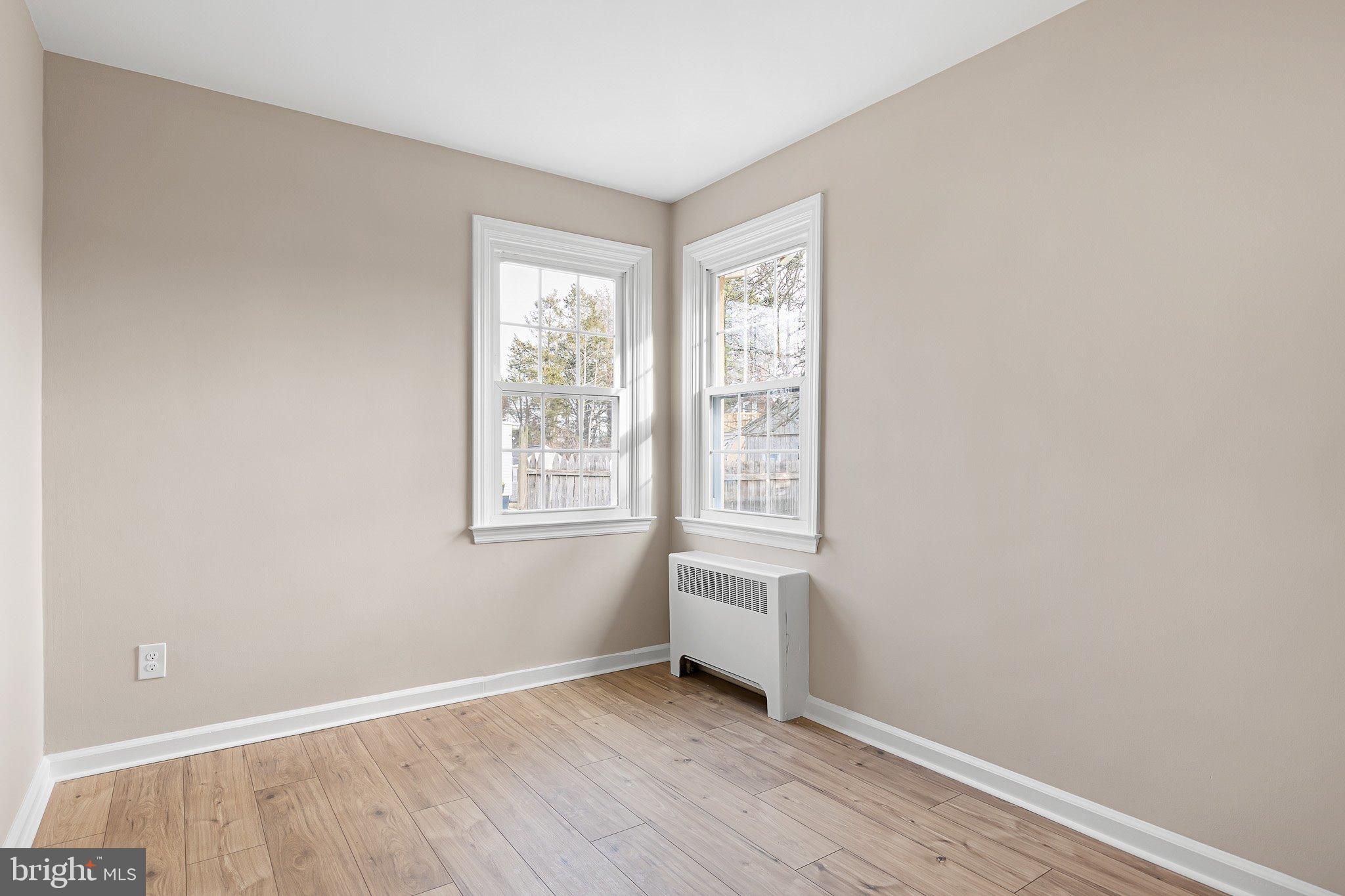 15 Irwin Avenue New Castle, DE 19720 - Photo 17 of 29 an empty room with wooden floor and windows