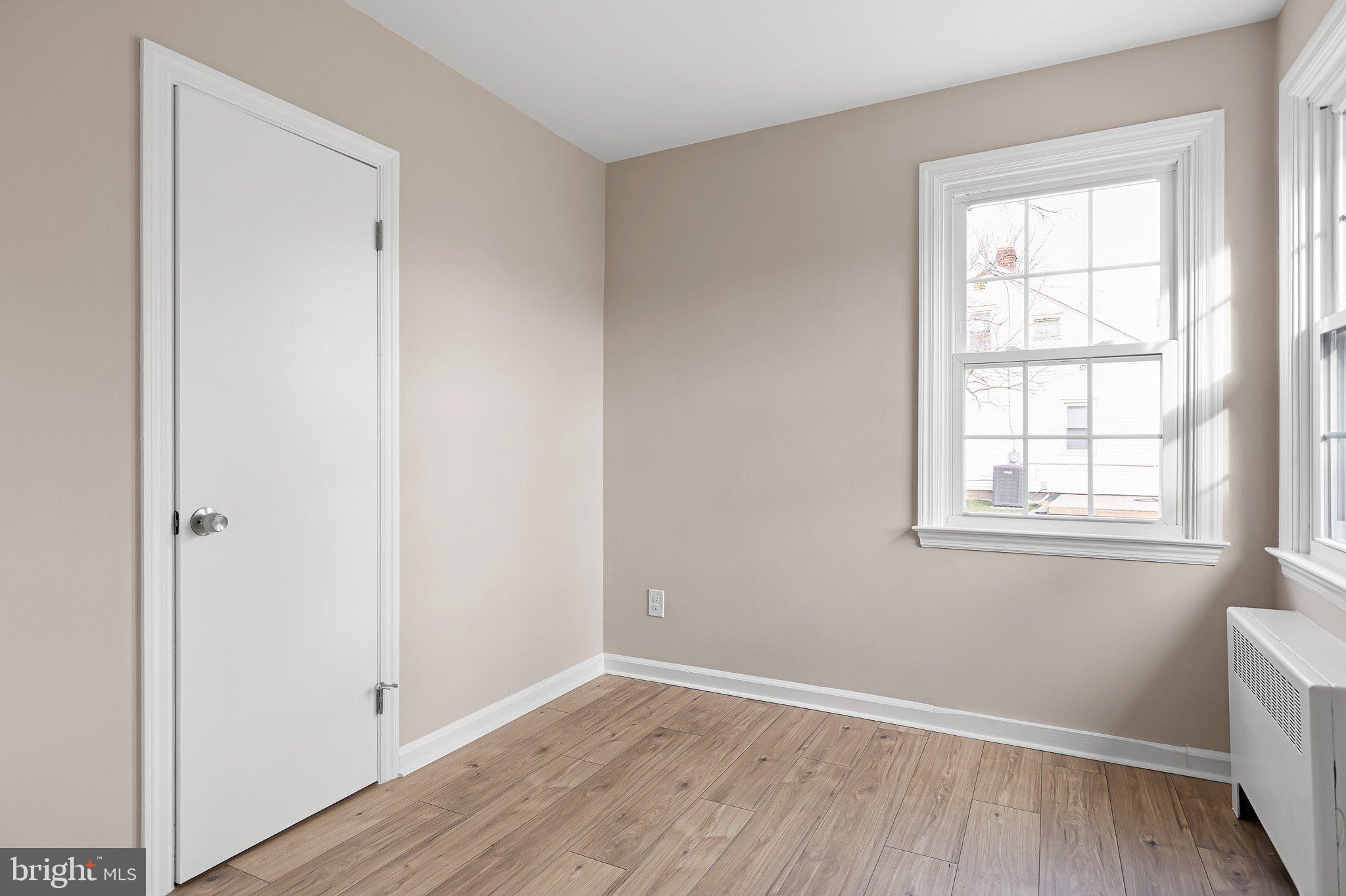 15 Irwin Avenue New Castle, DE 19720 - Photo 18 of 29 an empty room with wooden floor and windows