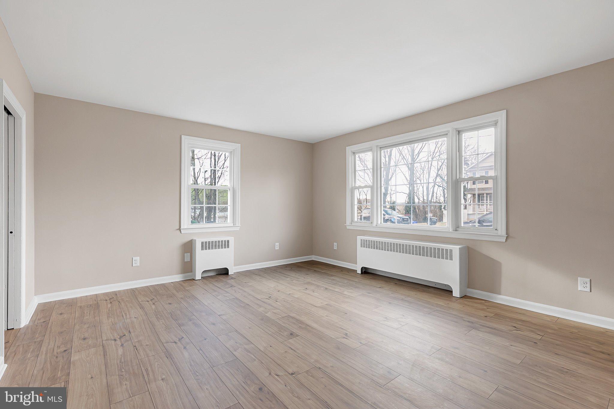 15 Irwin Avenue New Castle, DE 19720 - Photo 4 of 29 an empty room with wooden floor and windows