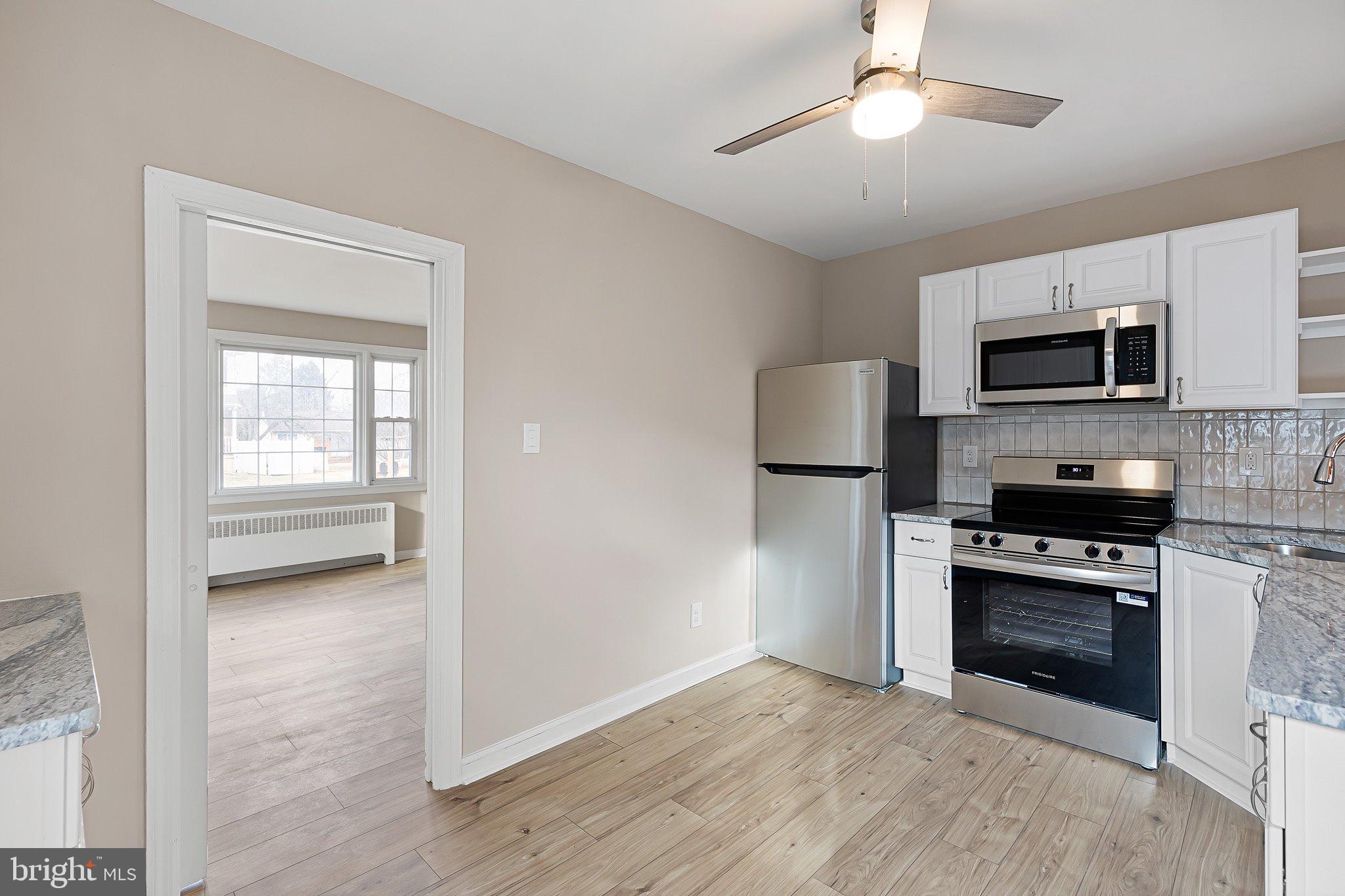 15 Irwin Avenue New Castle, DE 19720 - Photo 6 of 29 a view of a kitchen with microwave and stove top oven