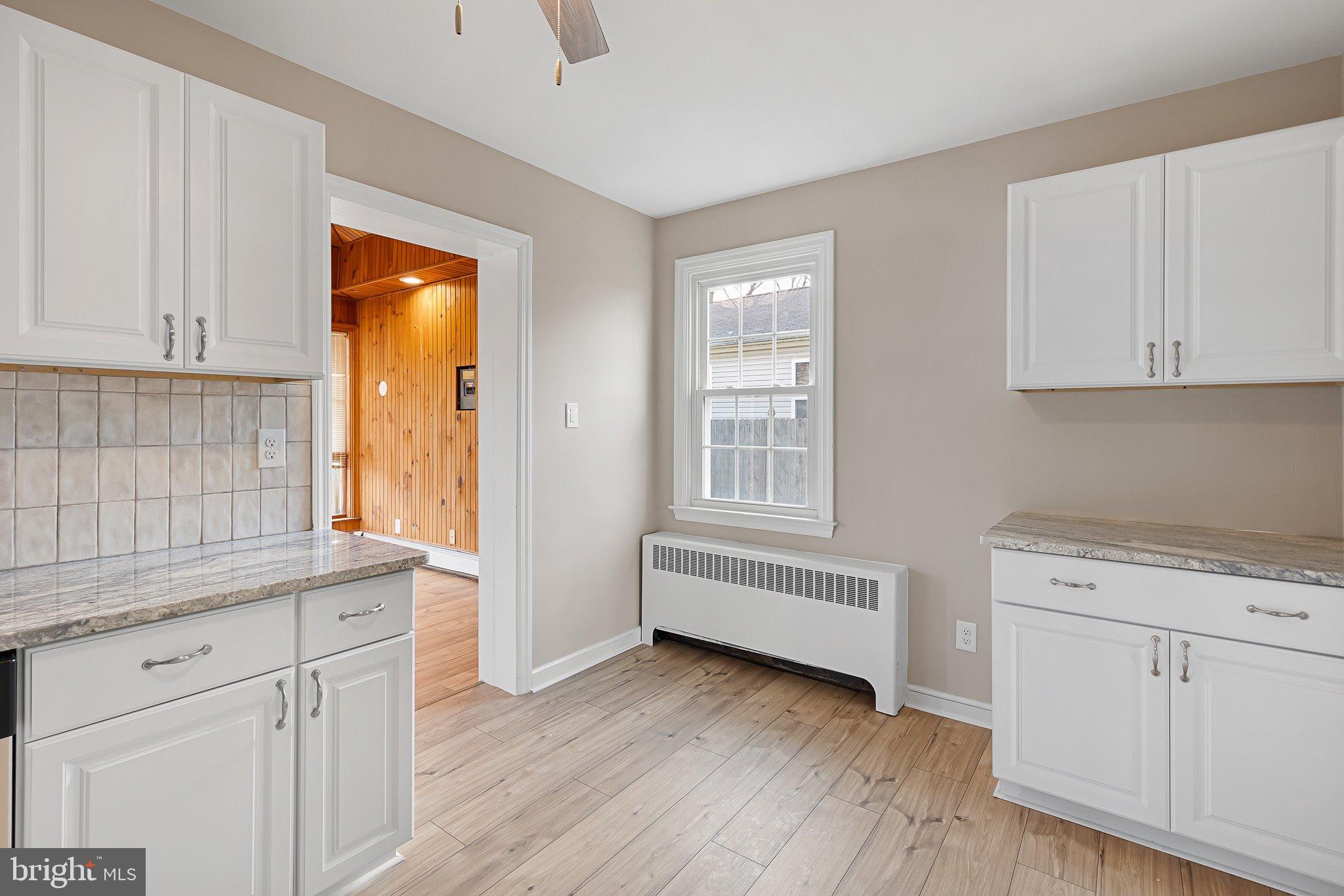 15 Irwin Avenue New Castle, DE 19720 - Photo 8 of 29 a kitchen with granite countertop white cabinets and white appliances