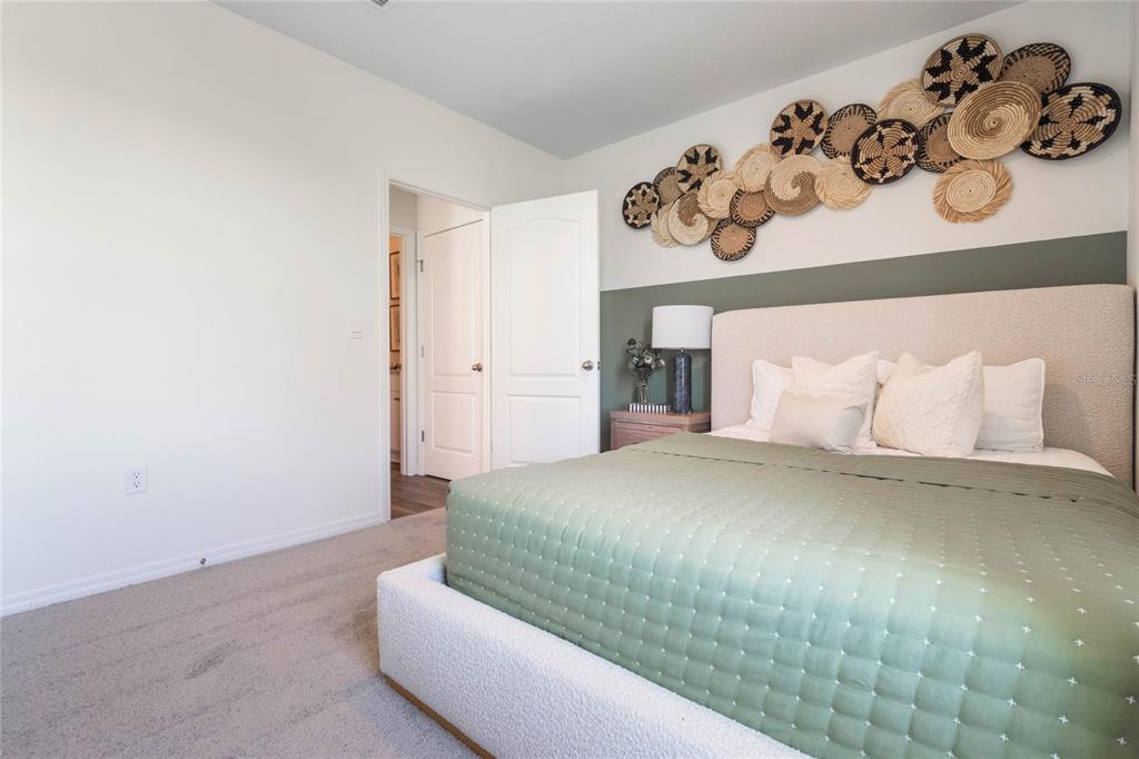 3441 Nettle Loop Tavares, FL 32778 - Photo 18 of 29 a bedroom with a bed and cabinets