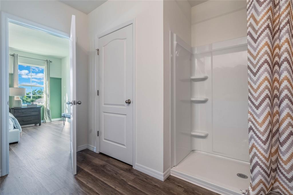 3441 Nettle Loop Tavares, FL 32778 - Photo 22 of 29 a view of a hallway with wooden floor and a living room
