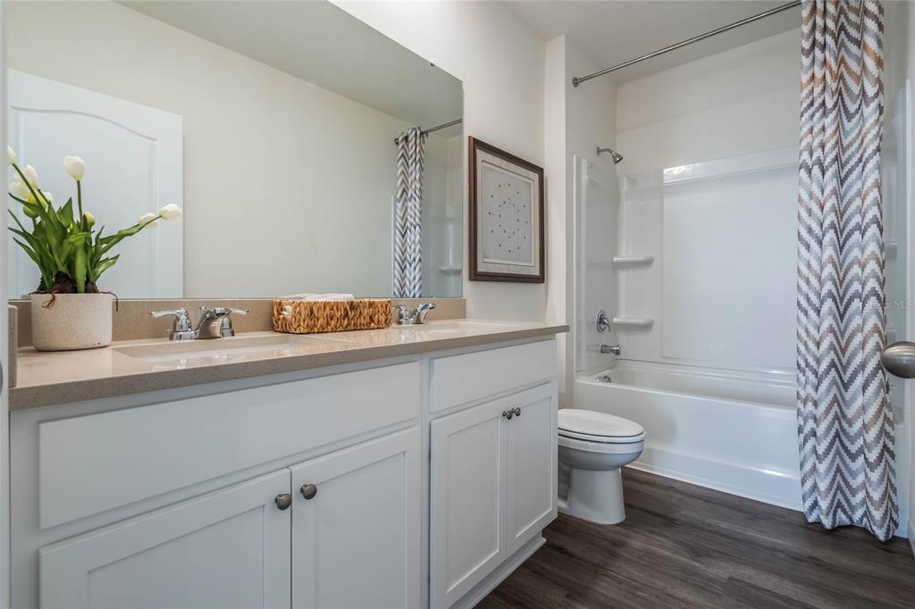 3441 Nettle Loop Tavares, FL 32778 - Photo 24 of 29 a bathroom with a sink a toilet and shower